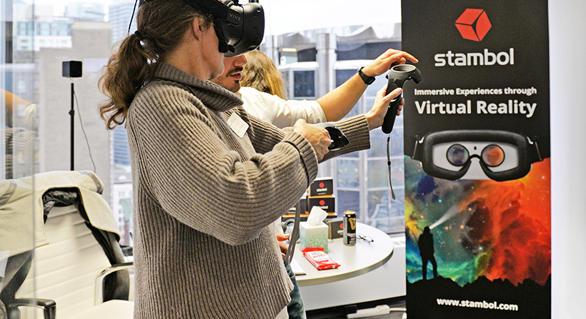 Woman trying HTC Vive headset at Stambol Studios booth