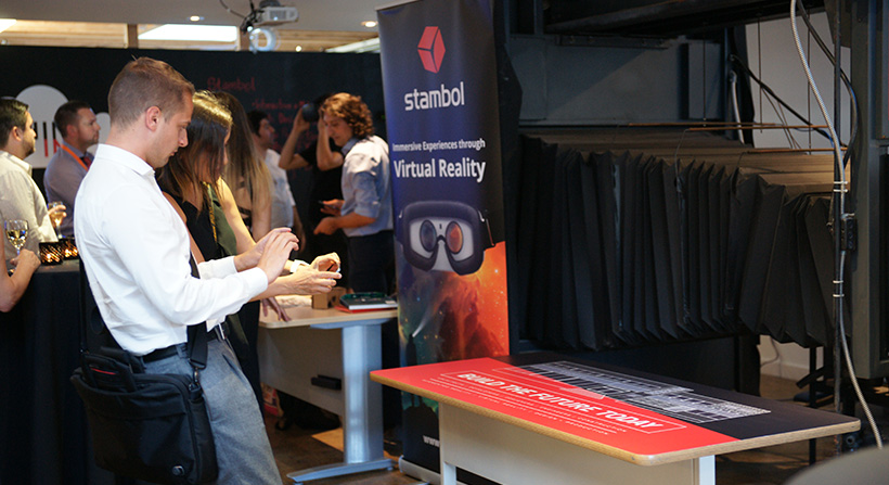 Young male guest trying Augmented Reality app printed on table