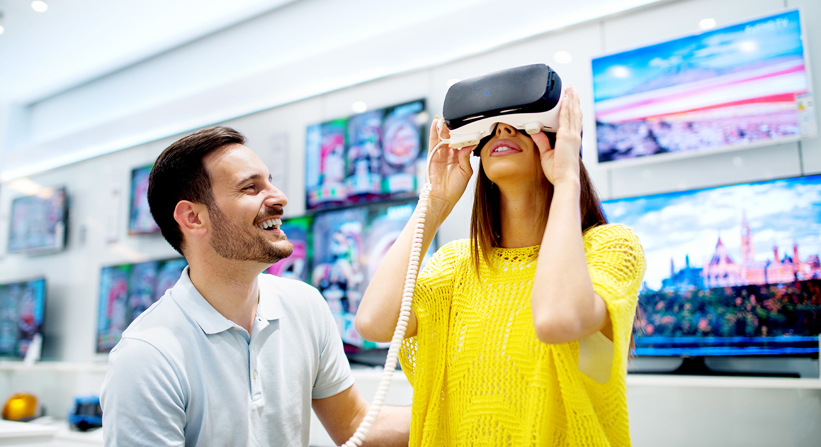 Young couple trying on virtual reality headset in a store