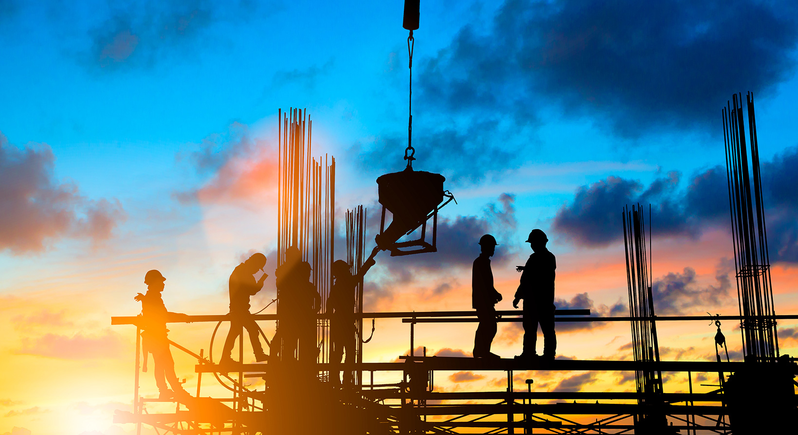 Silhouette of construction workers on a site