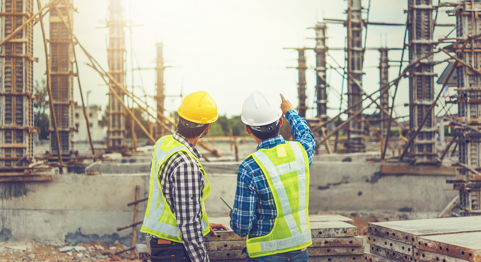 Two young man architect on a building construction site