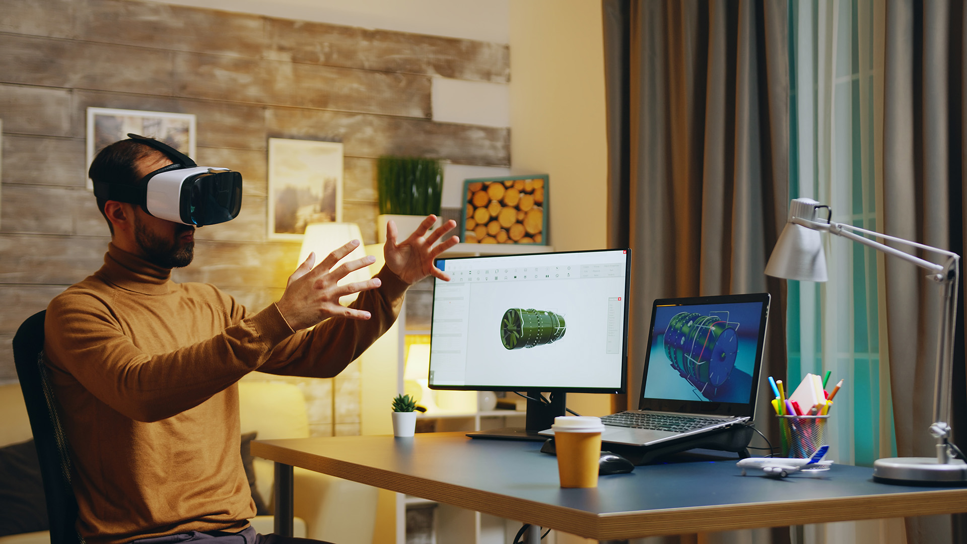 Engineer using virtual reality headset for remote collaboration at his desk at home