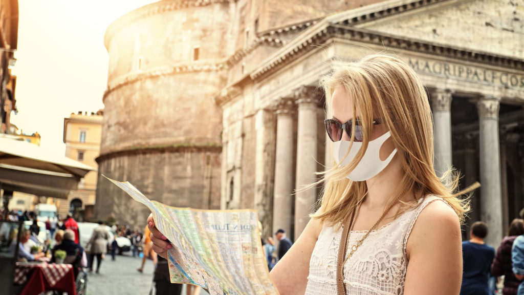 tourist visits the map with a rome and a pantheon in a mask