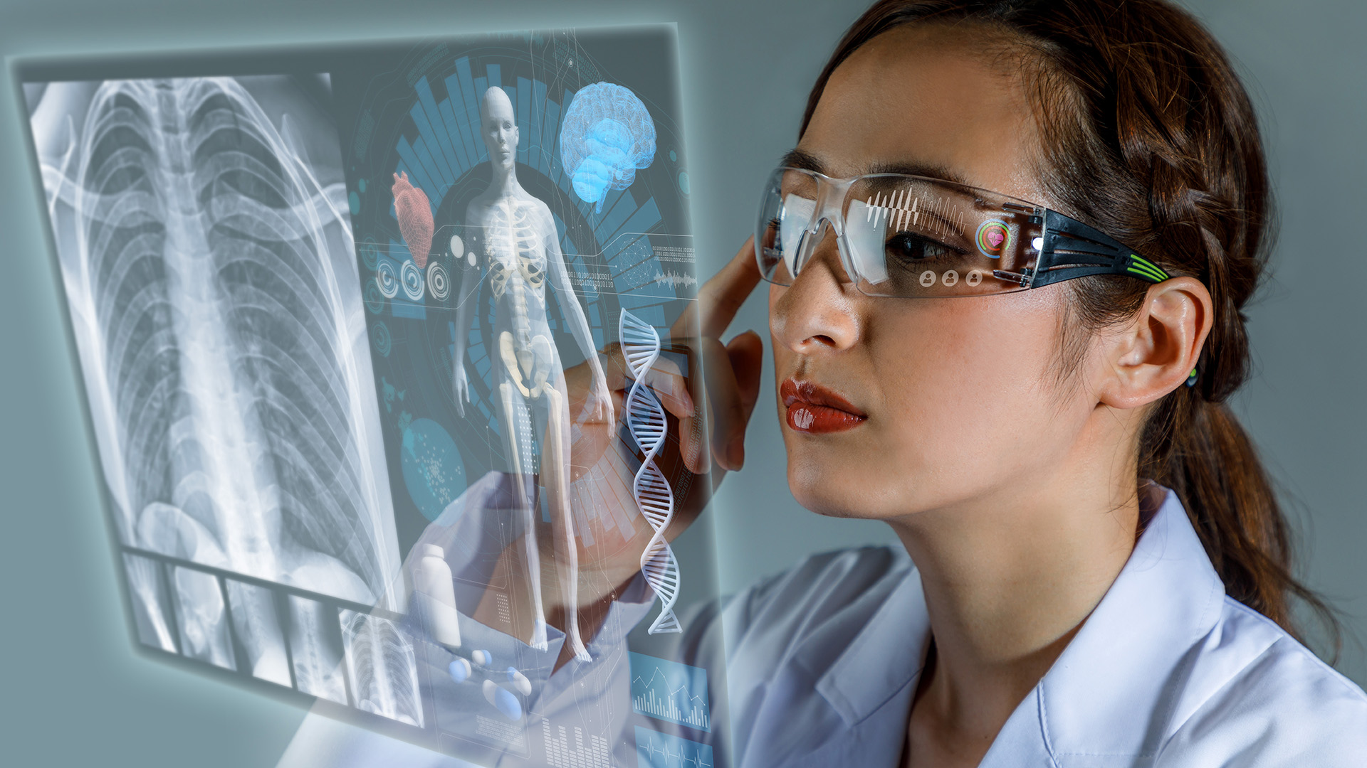 young female doctor looking at hologram screen displaying electronic medical records